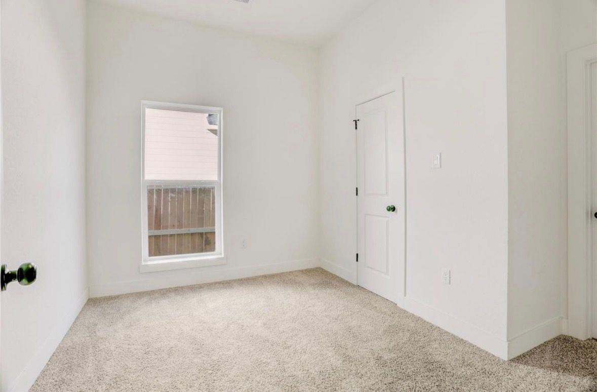 Bedroom with new carpet and window