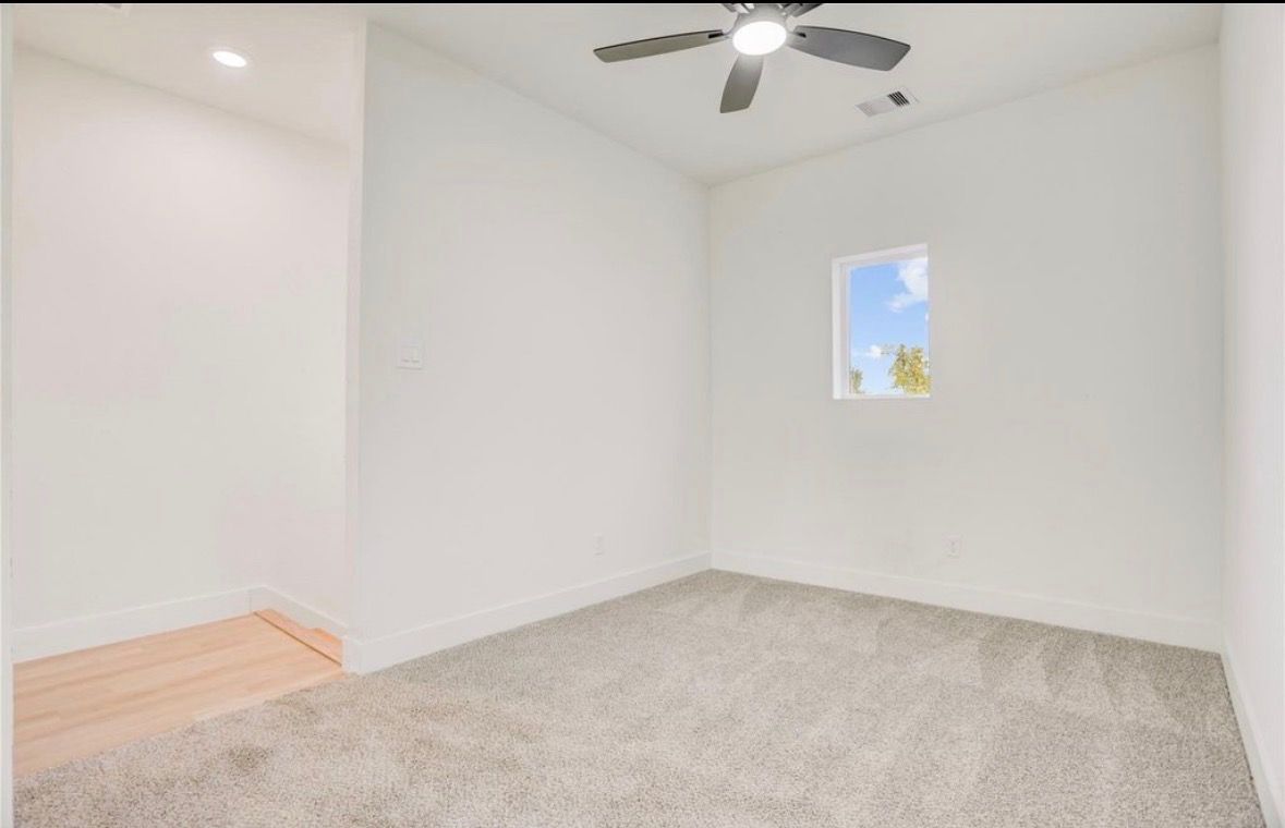 Bedroom with ceiling fan and new carpet