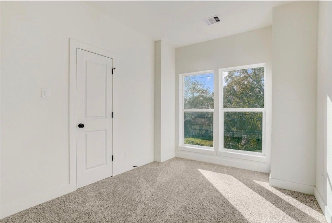 Bedroom with new carpet and closet door