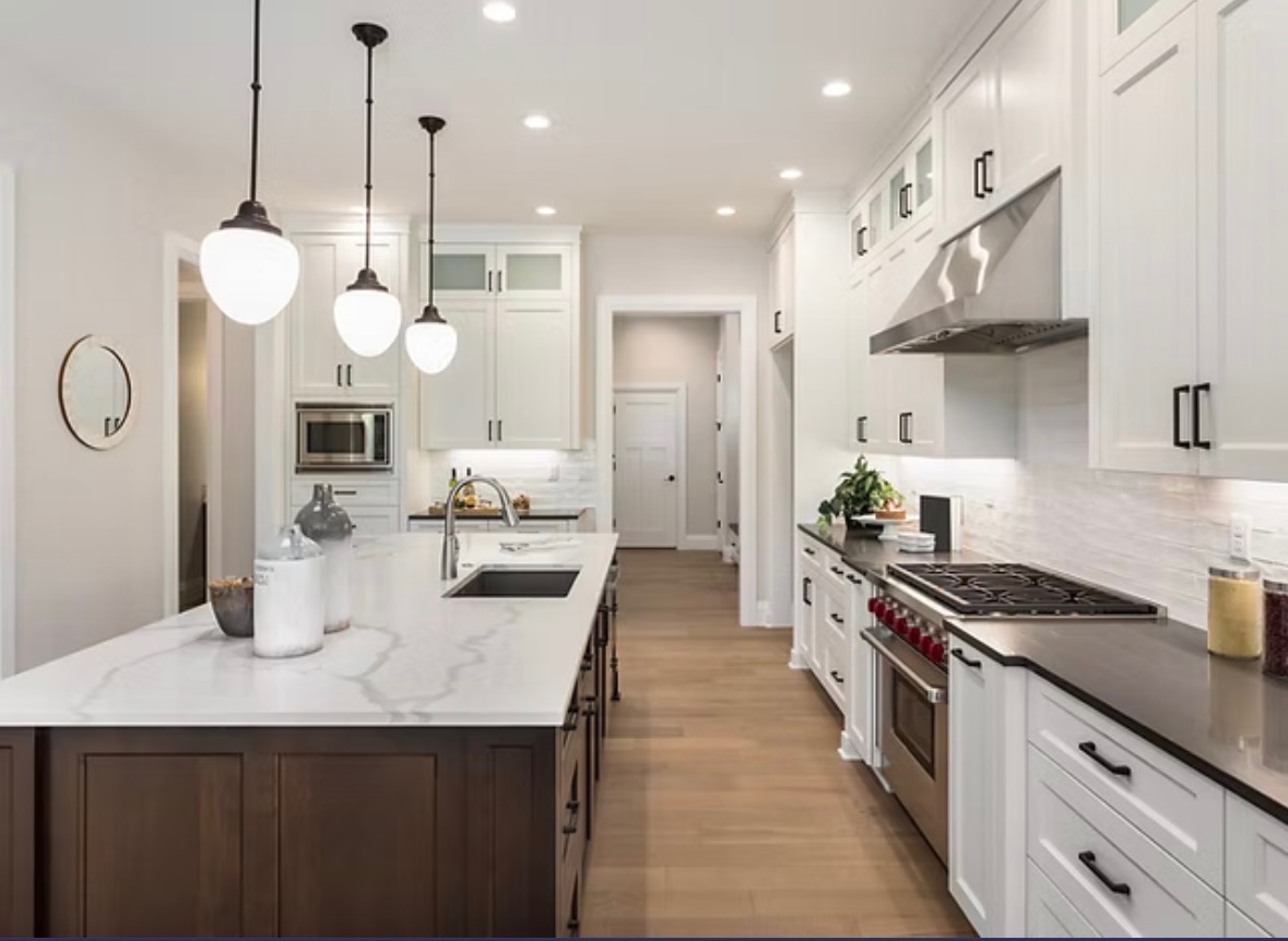 Coastal blue custom kitchen cabinetry with brass hardware