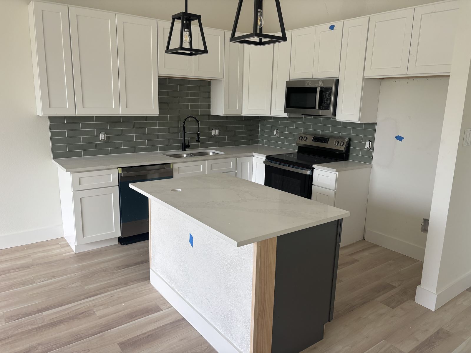 White cabinetry kitchen with gray subway tile backsplash