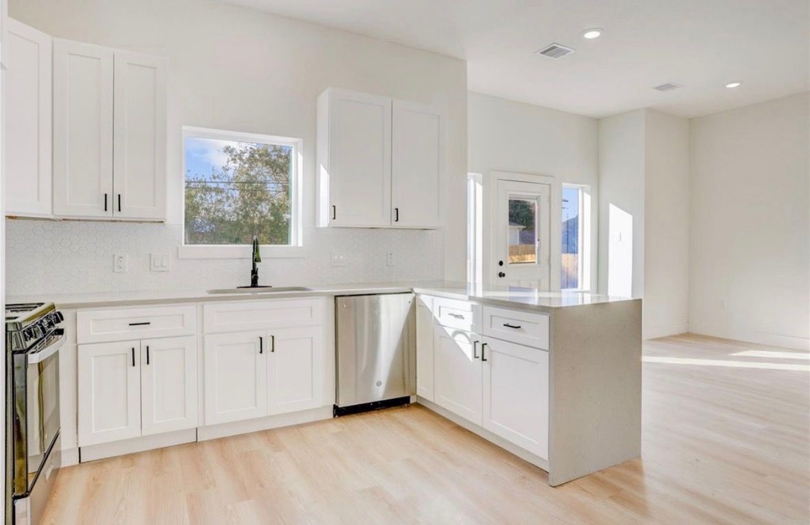 White kitchen cabinetry with hexagon tile backsplash