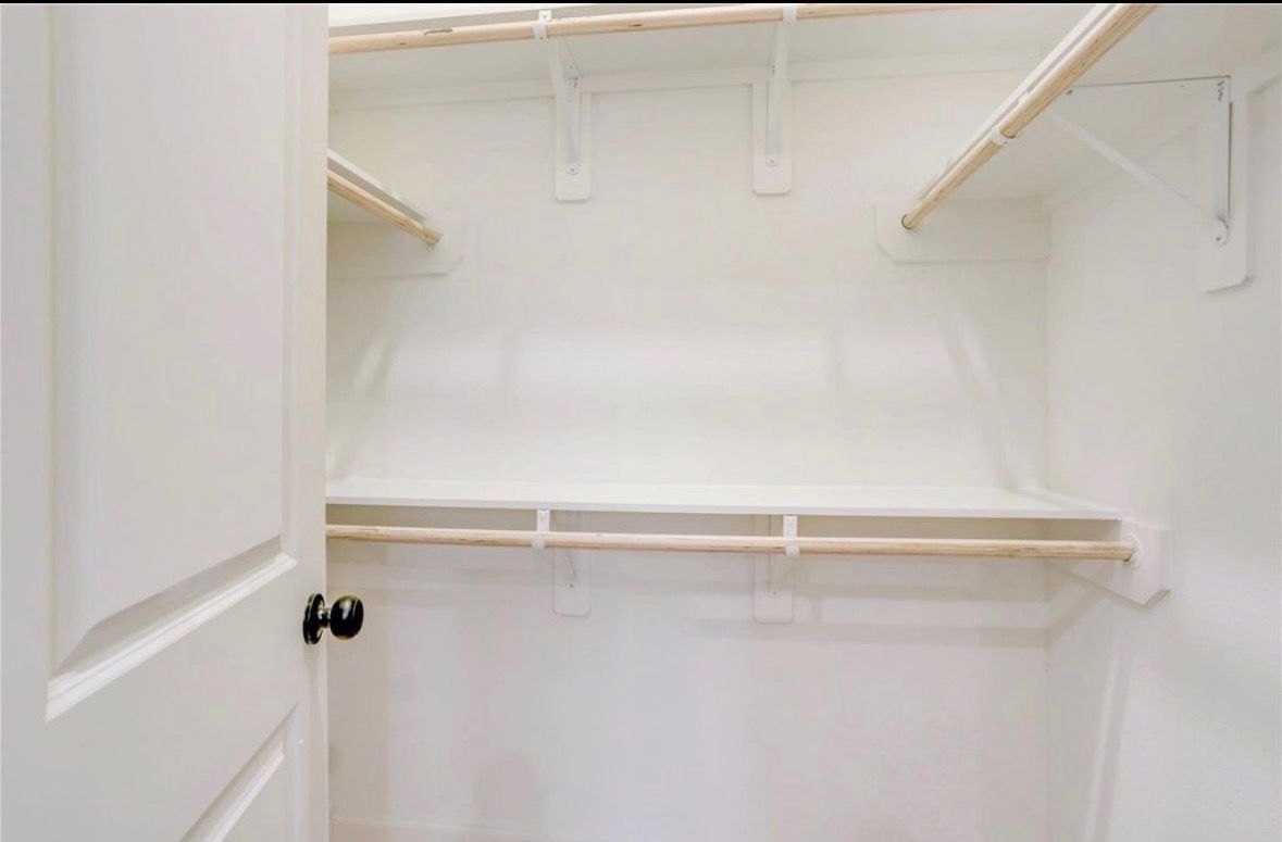 Walk-in closet with custom shelving and hanging rods